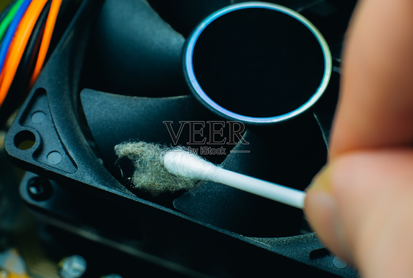 旧个人电脑的内部细节。肮脏的冷却器。男人正在用刷子清洁风扇。宏,关闭。照片摄影图片