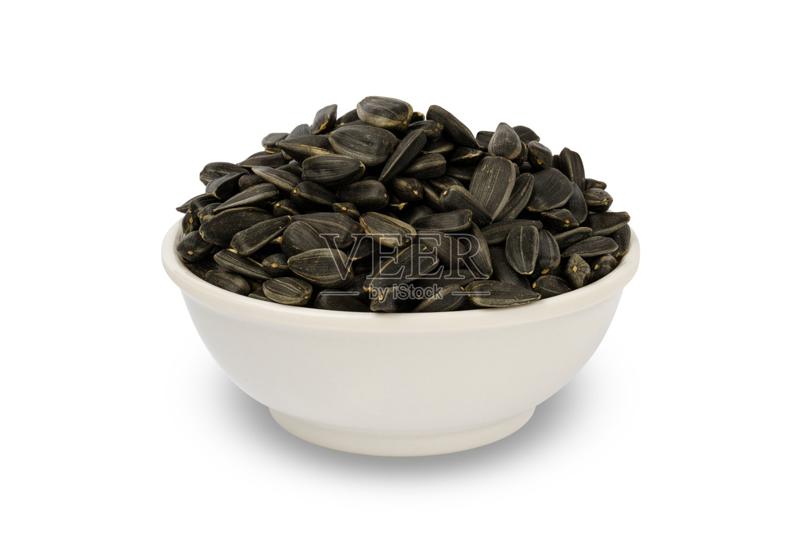 葵花籽在碗中孤立，上白照片摄影图片