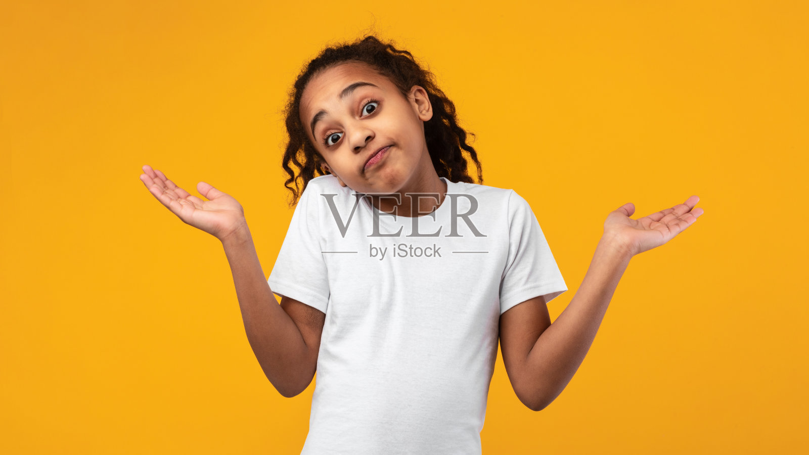 我不知道。困惑不解的黑人女孩在工作室耸耸肩照片摄影图片