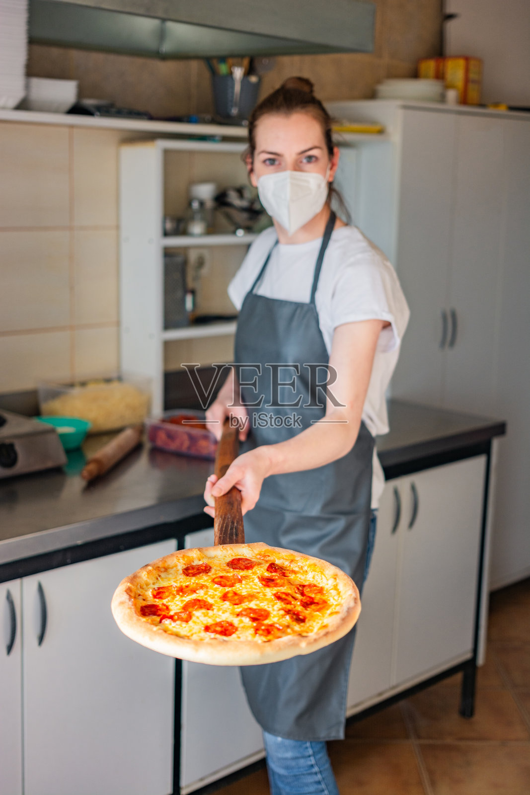 年轻的厨师拿着披萨皮照片摄影图片