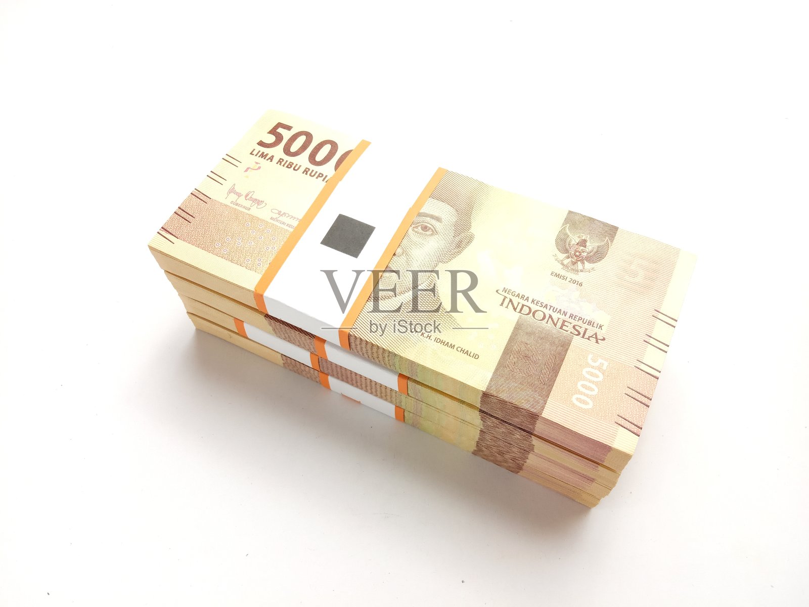 平铺，叠5000卢比的印尼货币，在白色的背景照片摄影图片