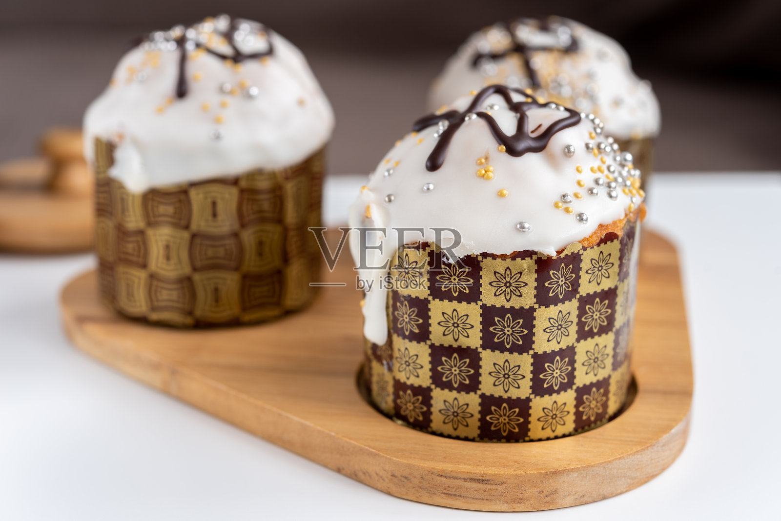 在一个木制托盘上浇上糖霜和巧克力的复活节蛋糕照片摄影图片