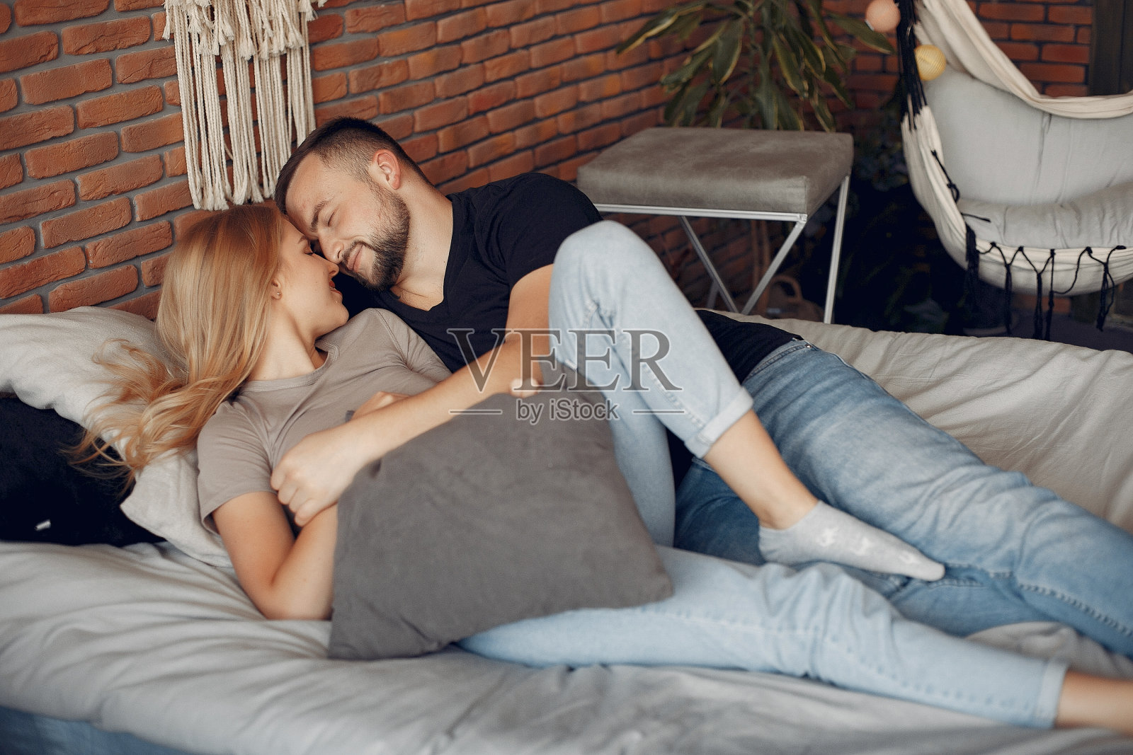 一对夫妇坐在房间的床上照片摄影图片