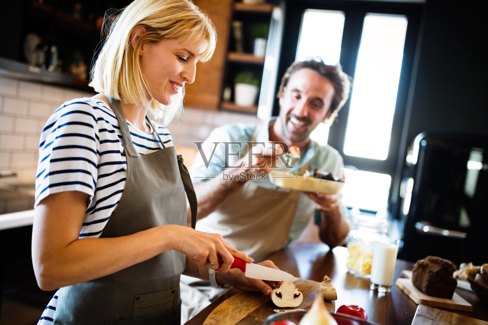 幸福的年轻夫妇在厨房里一起做饭的肖像照片摄影图片