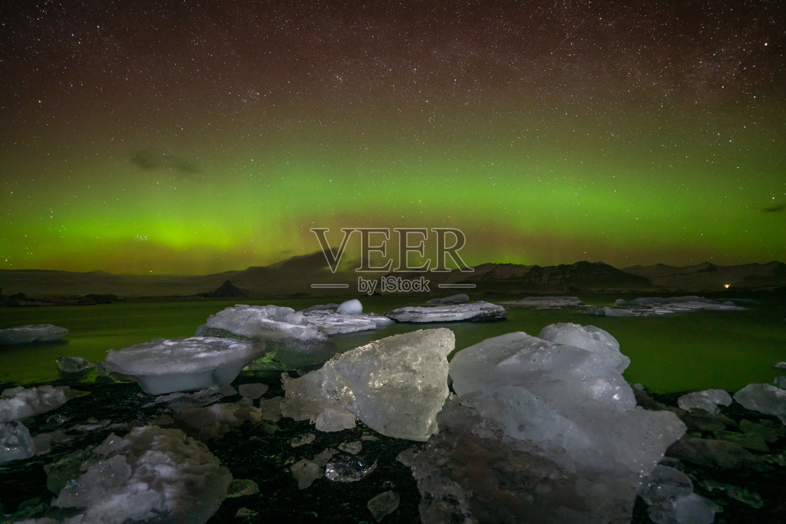 令人难以置信的北极光活动在冰岛海岸上空照片摄影图片