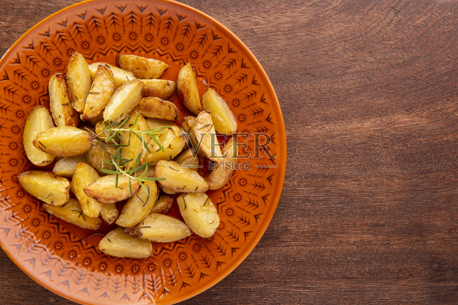 一份用橄榄油和迷迭香烤土豆照片摄影图片