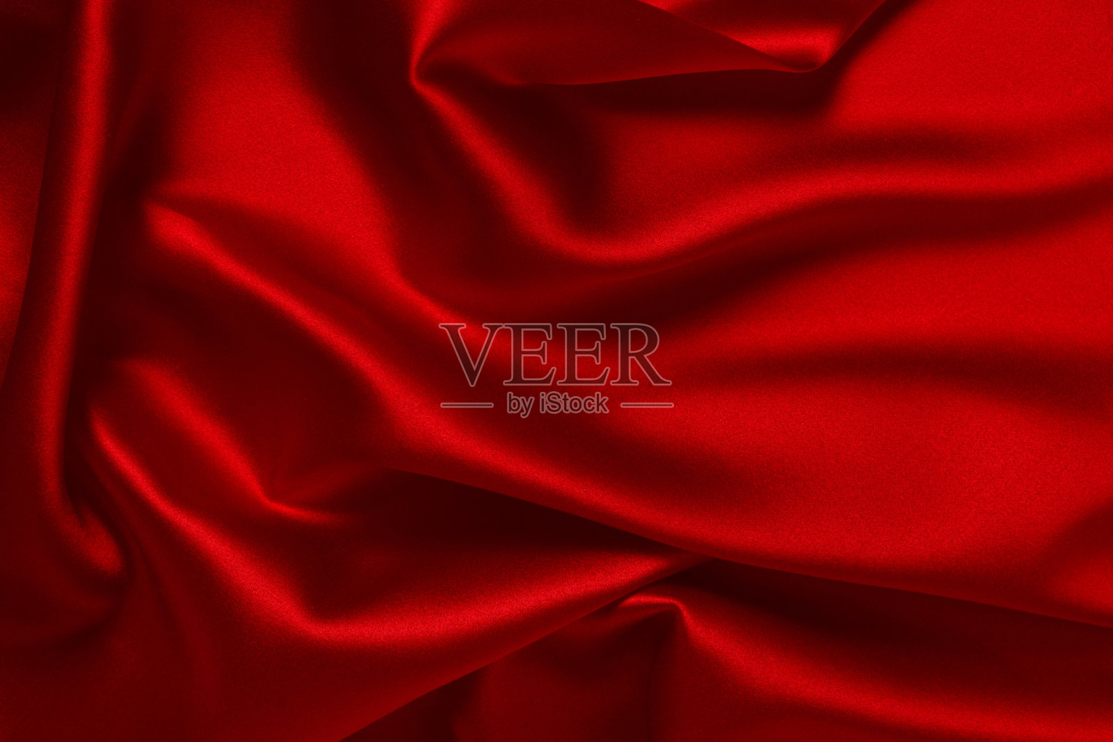 红色丝绸或豪华缎纹织物可作为抽象背景。前视图。照片摄影图片