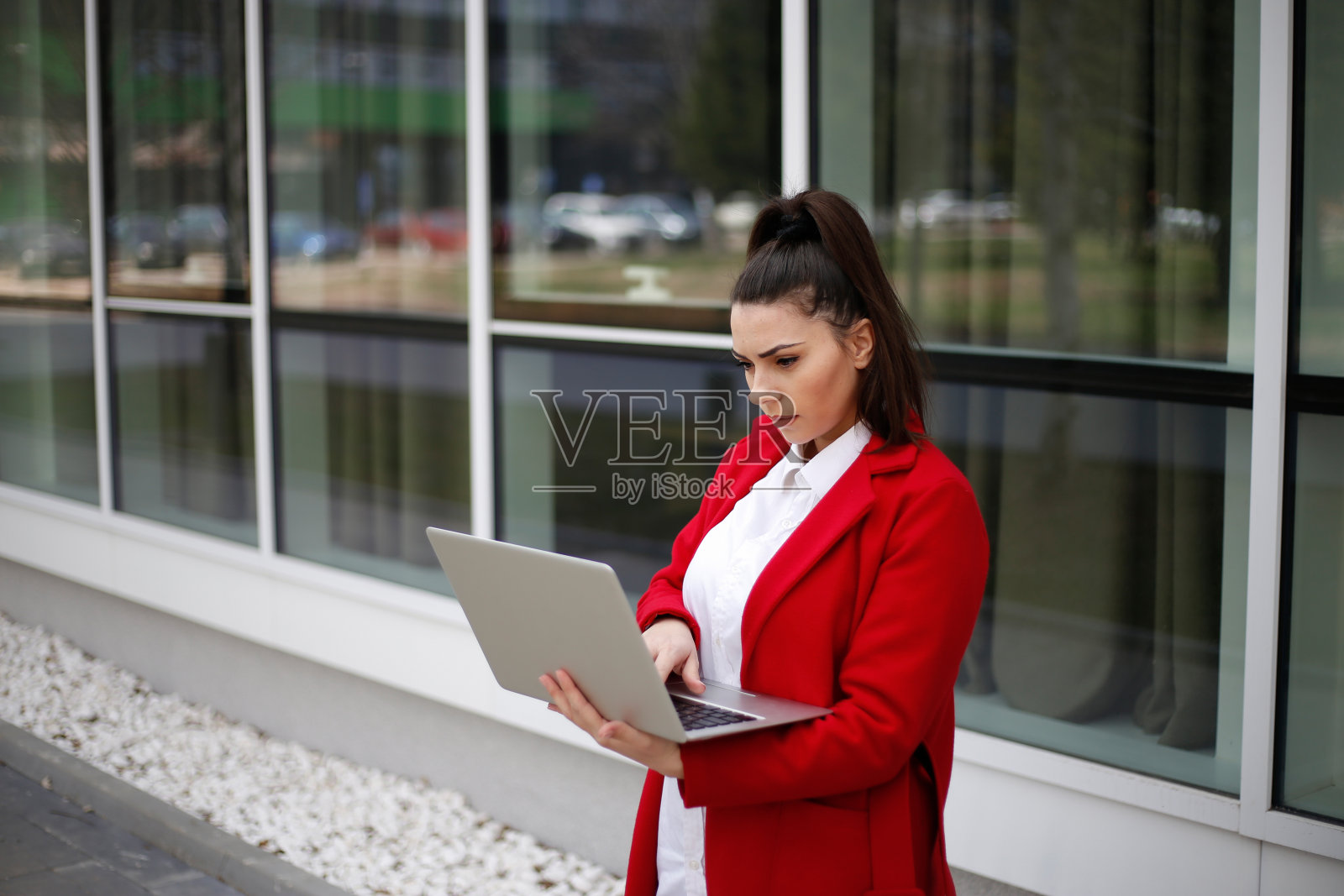 年轻的商业女性在户外使用笔记本电脑。库存图片照片摄影图片