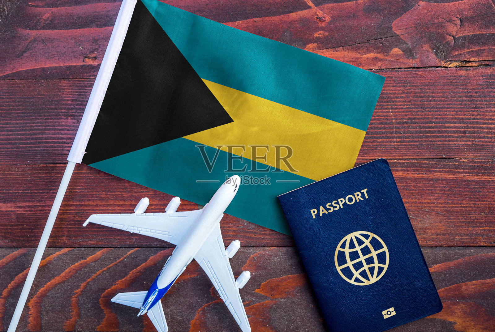 巴哈马国旗，护照和木制背景玩具飞机。照片摄影图片