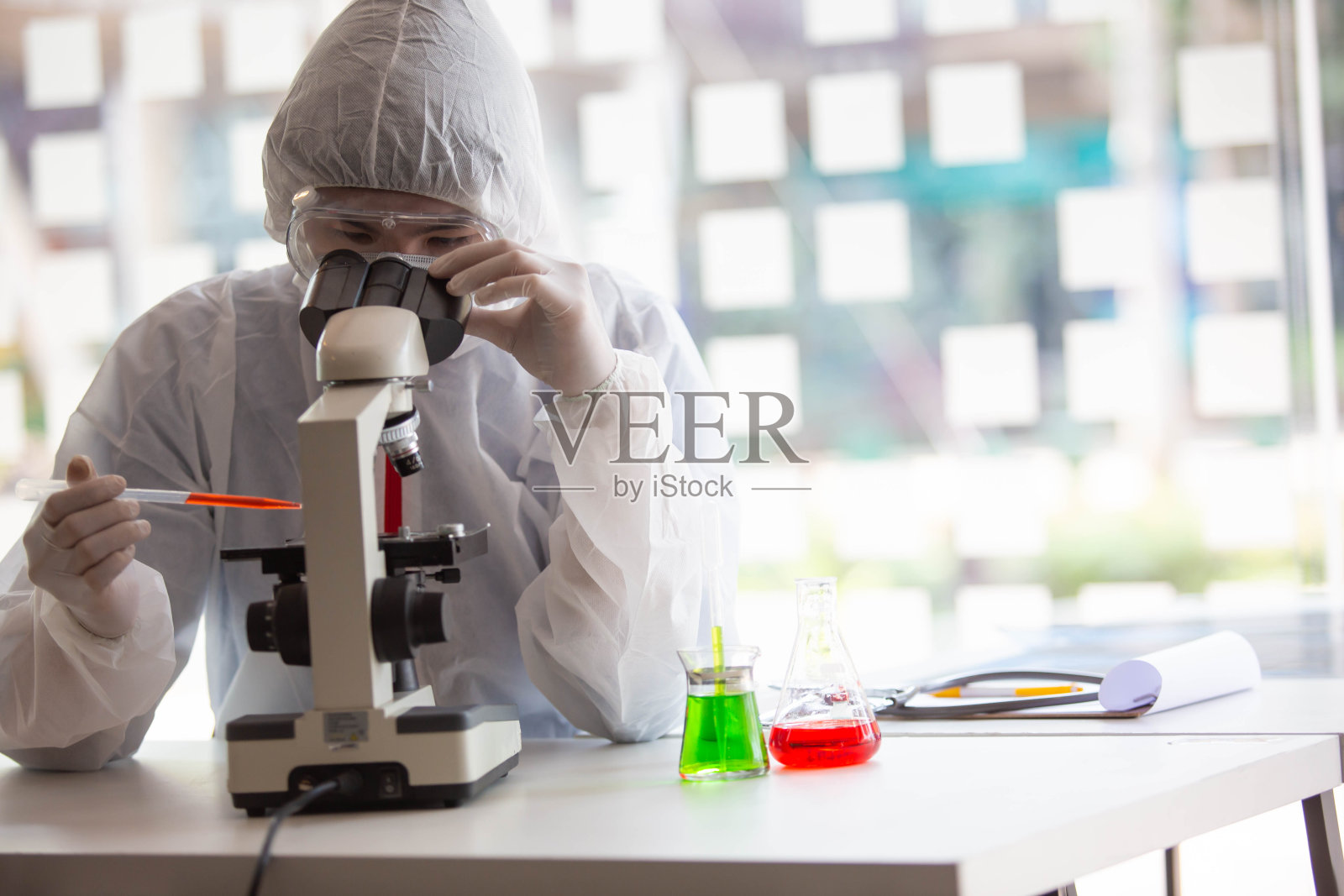 这名医生正在测试被冠状病毒Covid - 19污染的生物试管样本，并寻找对抗该病毒的疫苗或糖浆。在实验室和电影样本感染肺部照片摄影图片