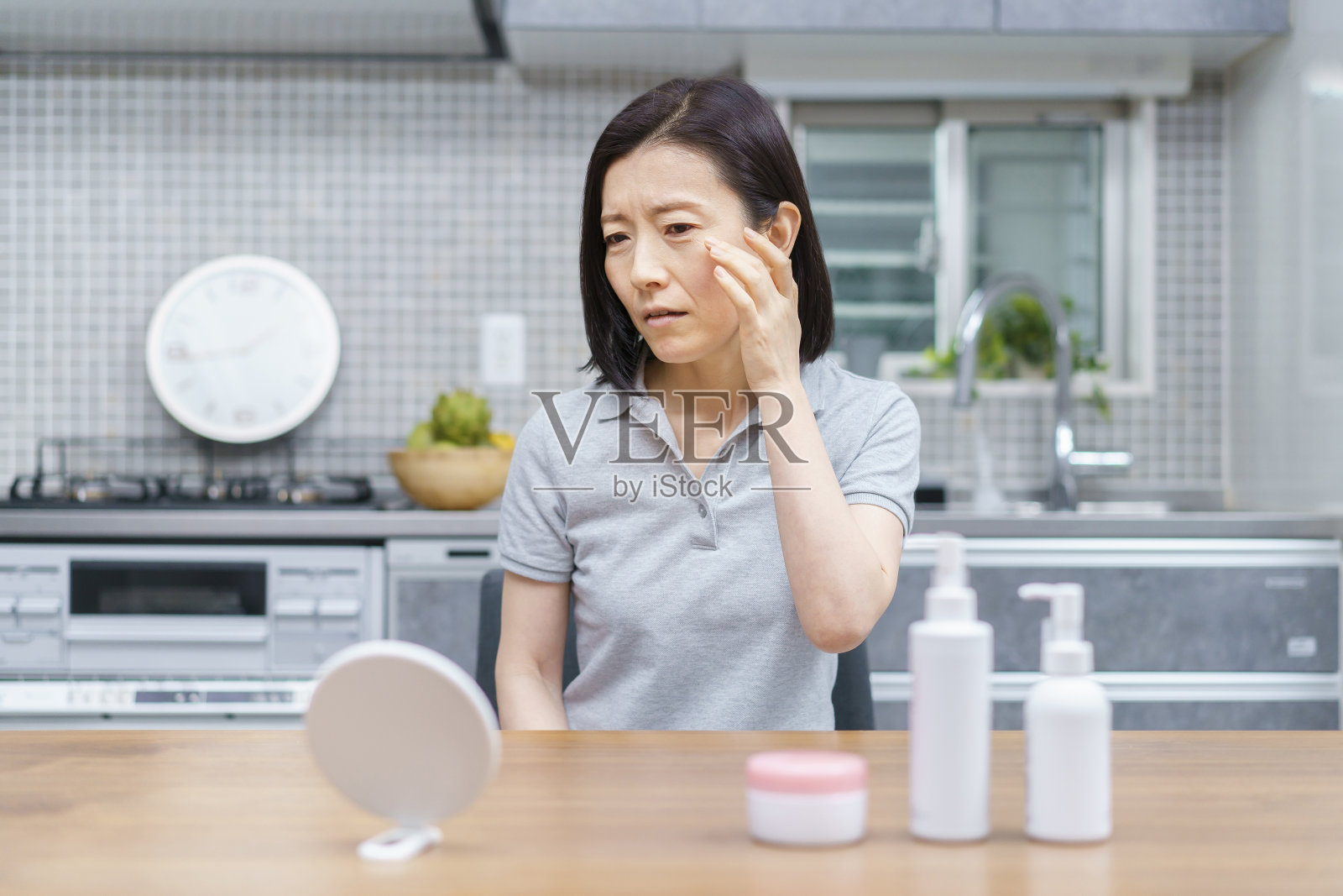 中年妇女正在焦急地检查皮肤状况照片摄影图片