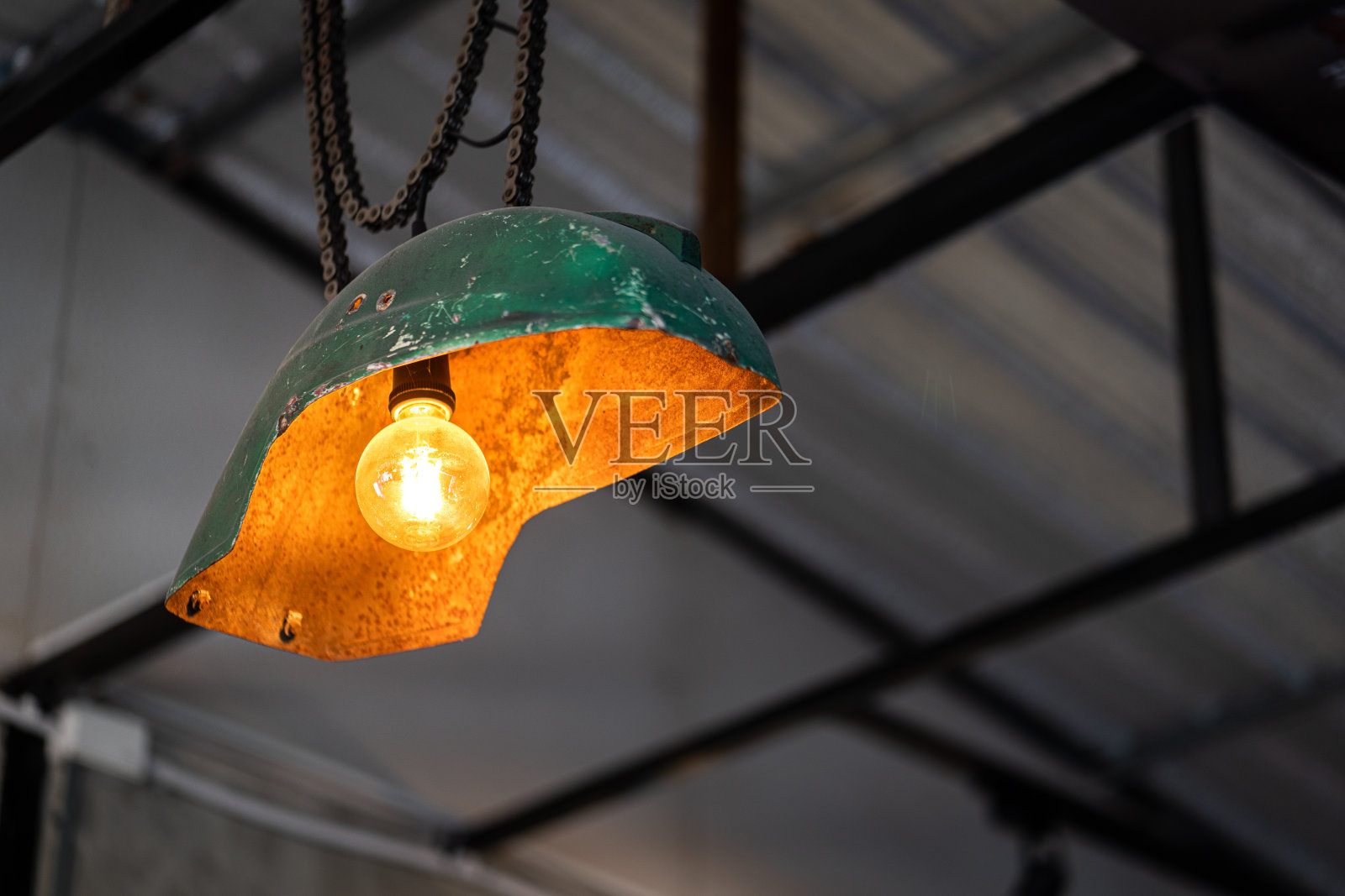 一种由自行车轮罩的金属部分改装而成的顶灯。照片摄影图片