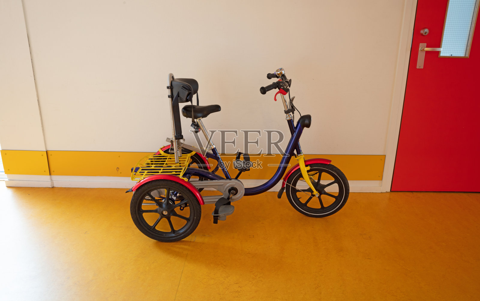 残疾儿童专用自行车，用于在建筑物内骑照片摄影图片