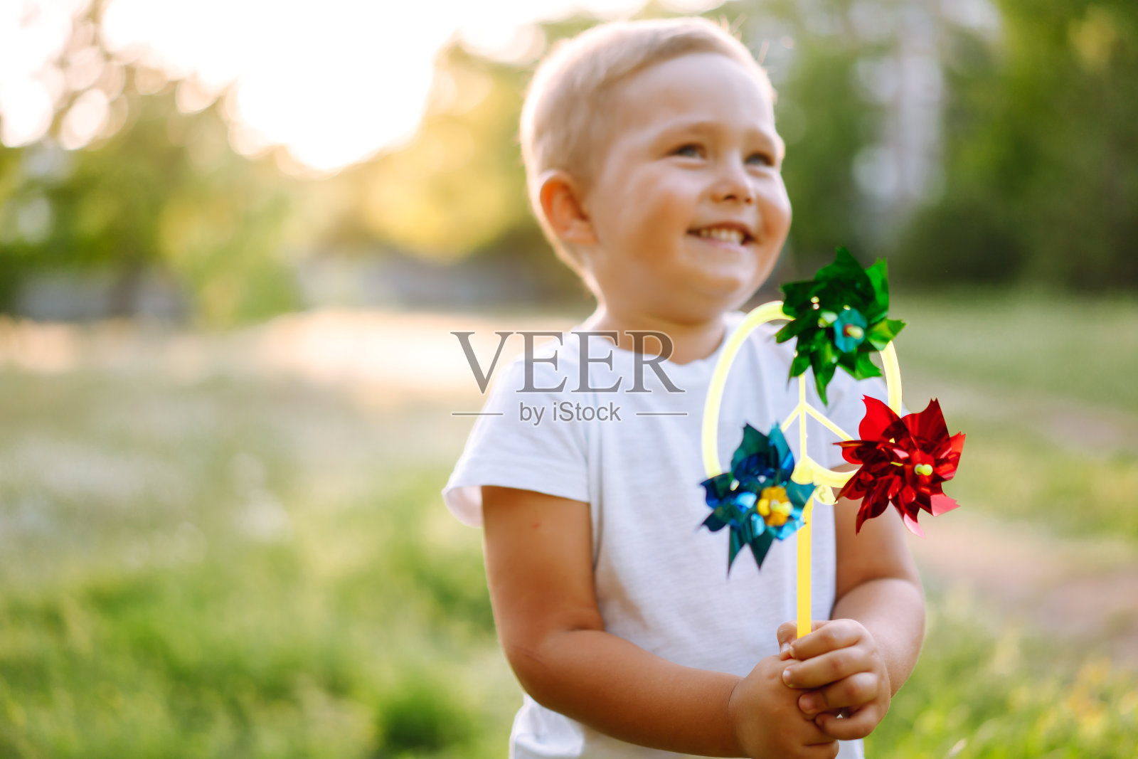 小男孩在夏天的公园里玩耍。可爱的孩子享受清新的春天天气。童年的时刻。照片摄影图片