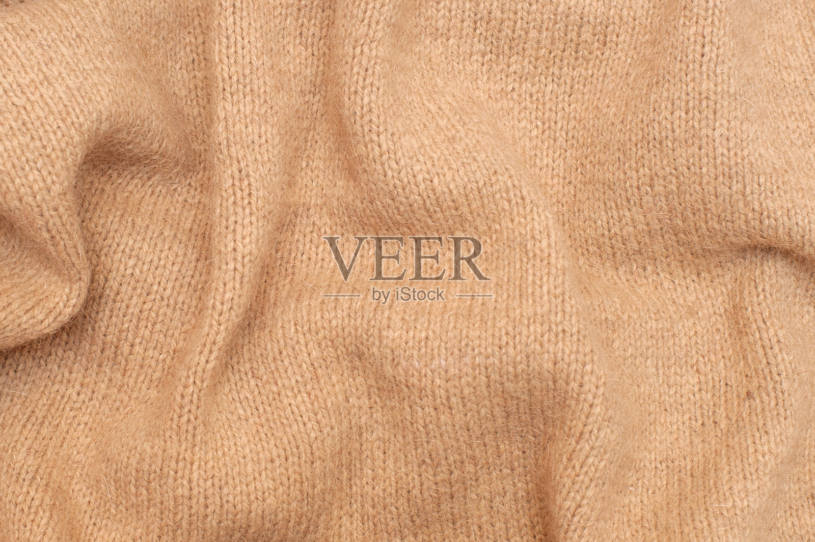米色针织质地。照片摄影图片