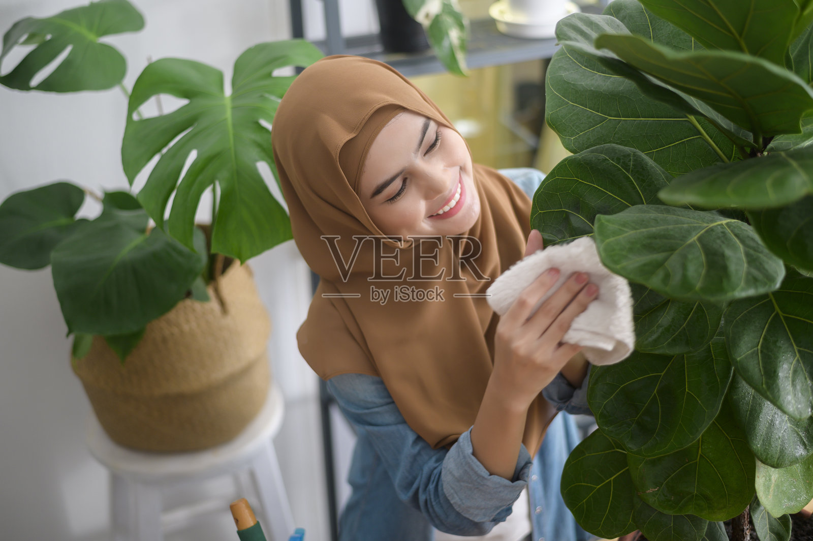 快乐的年轻穆斯林妇女享受和放松休闲活动在花园里的家照片摄影图片