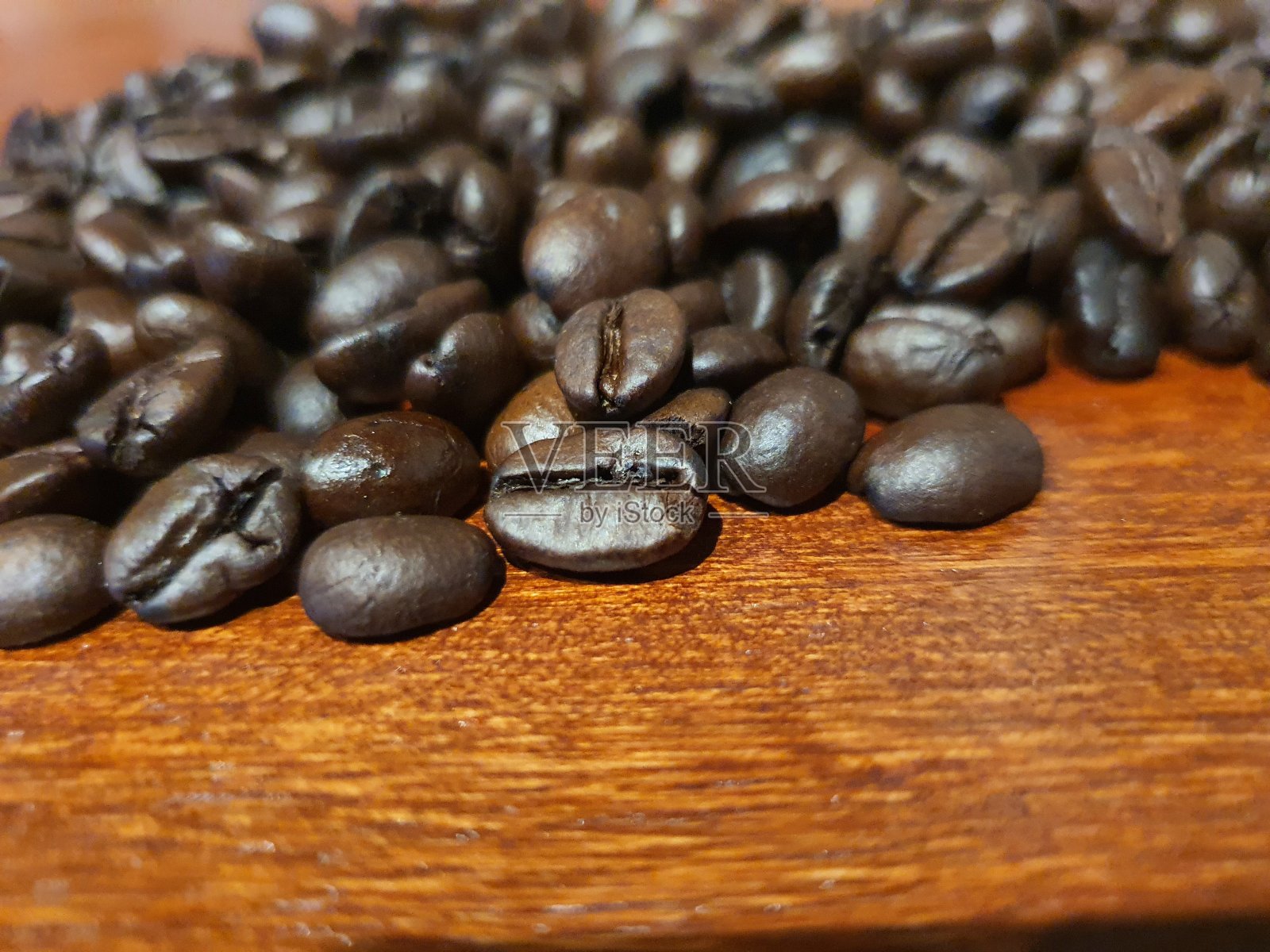 松散的咖啡豆在黑色的背景下烘烤。为您的设计复制空间照片摄影图片