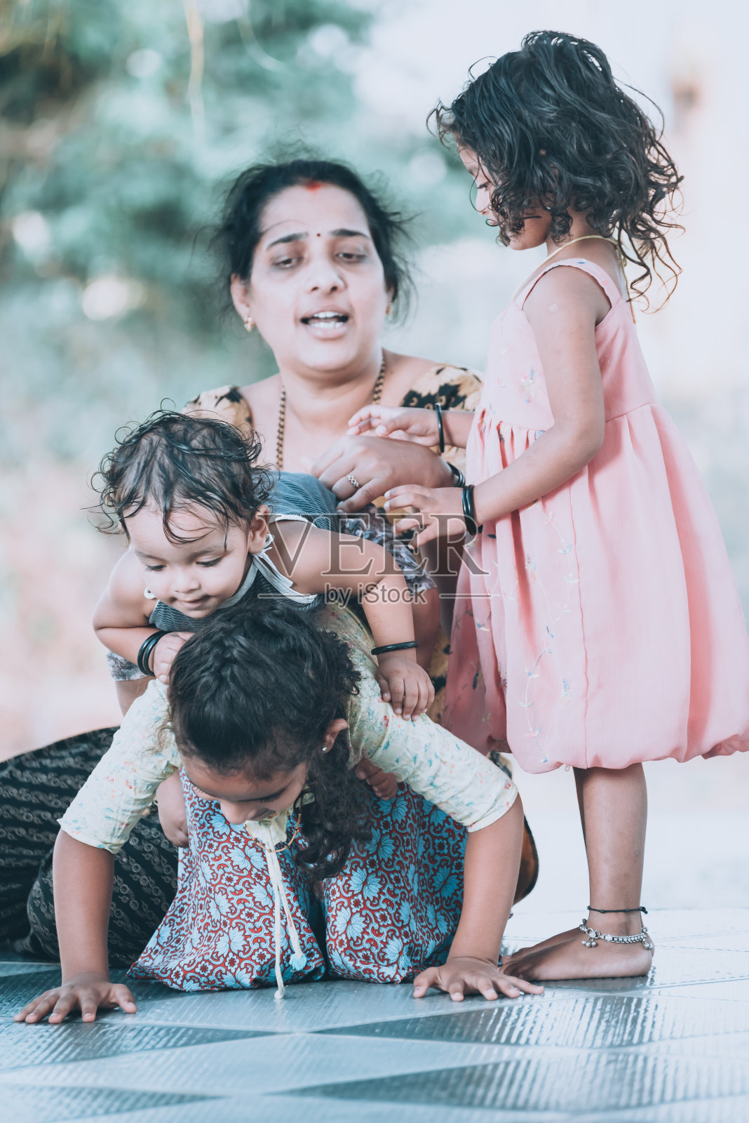 妈妈和她的孩子们在家门口玩照片摄影图片