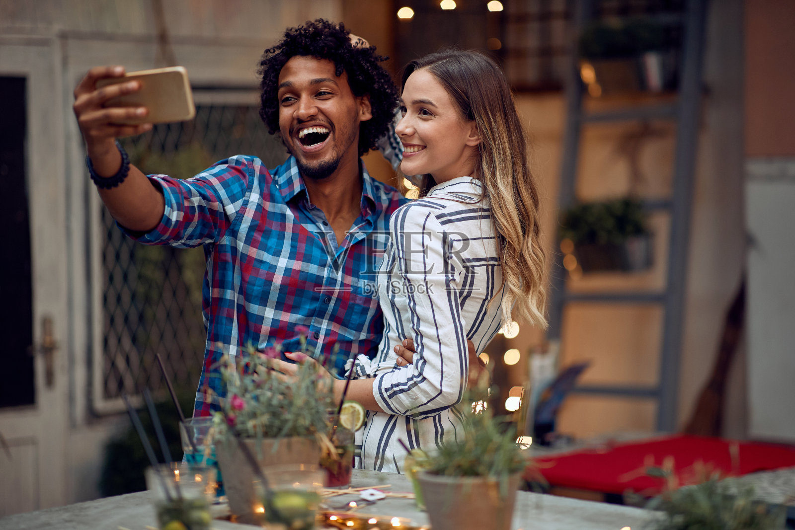 这对快乐的夫妇在露天生日派对上摆姿势自拍。高质量的友谊时光照片摄影图片