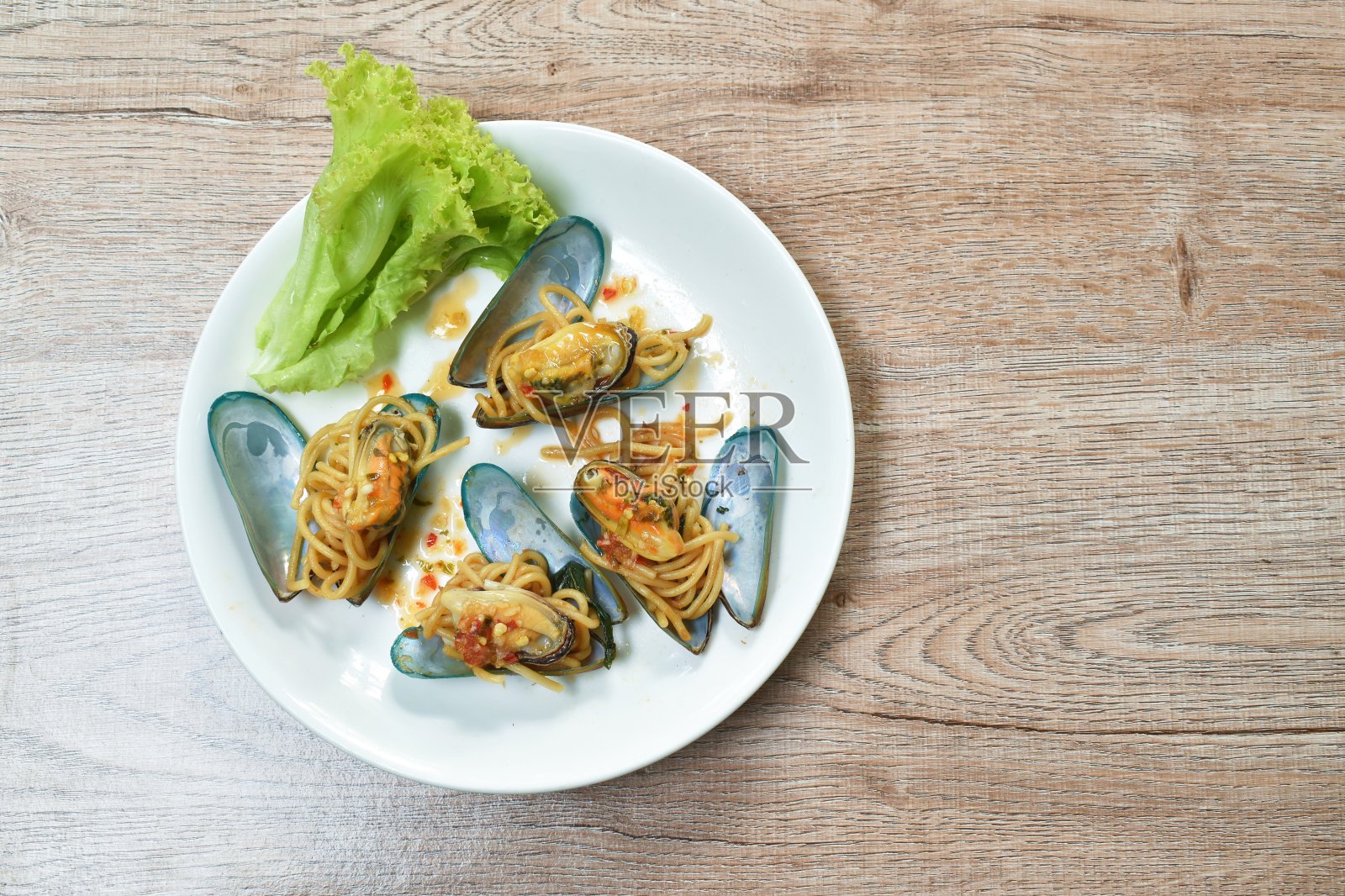 香辣意大利面配罗勒叶卷，贻贝调味辣椒酱照片摄影图片