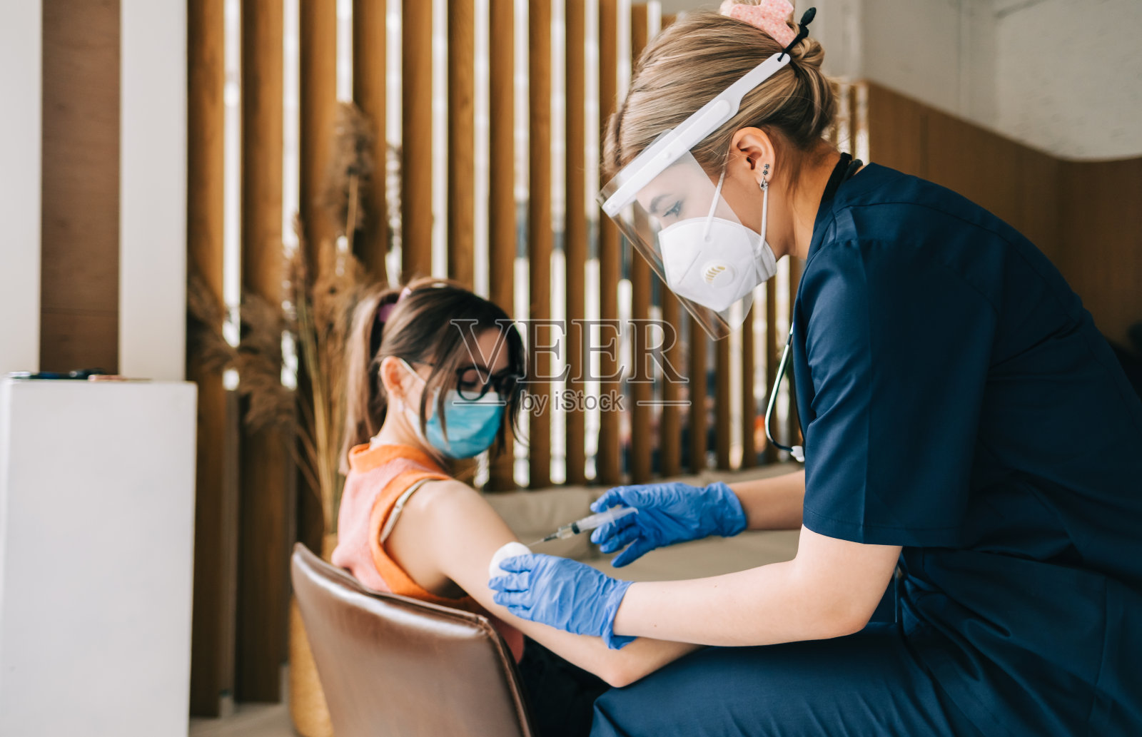 白种女性患者接受冠状病毒疫苗接种。在医院预约医生时进行肌肉注射。Covid-19接种疫苗。照片摄影图片