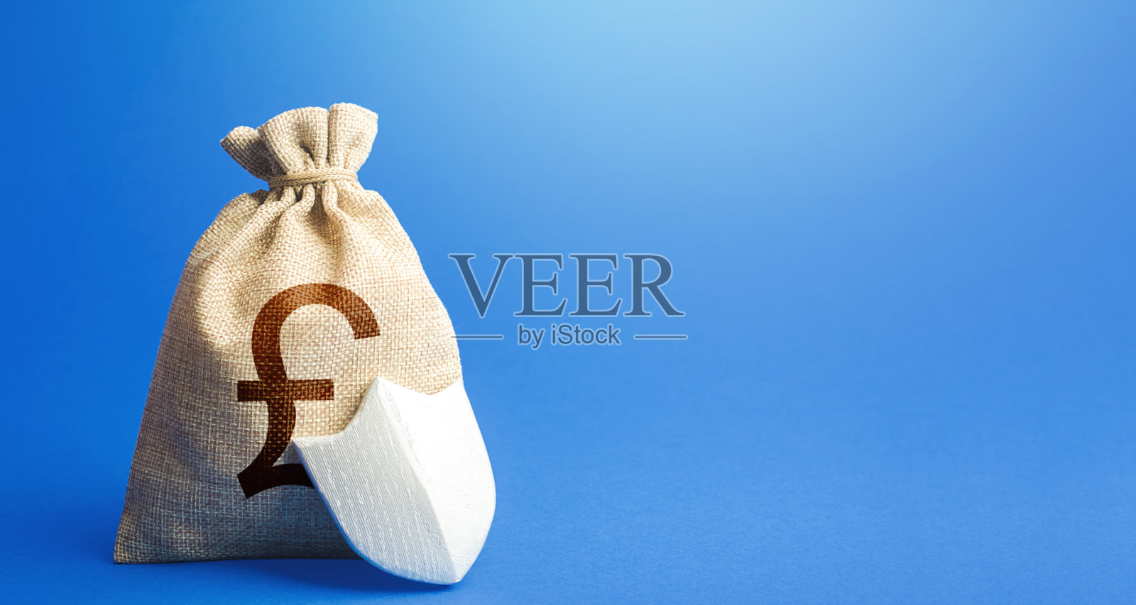 英镑钱袋和保护盾。保证存款。金融体系的实力。可持续银行。固定利率存款。投资安全。缓解做生意。照片摄影图片