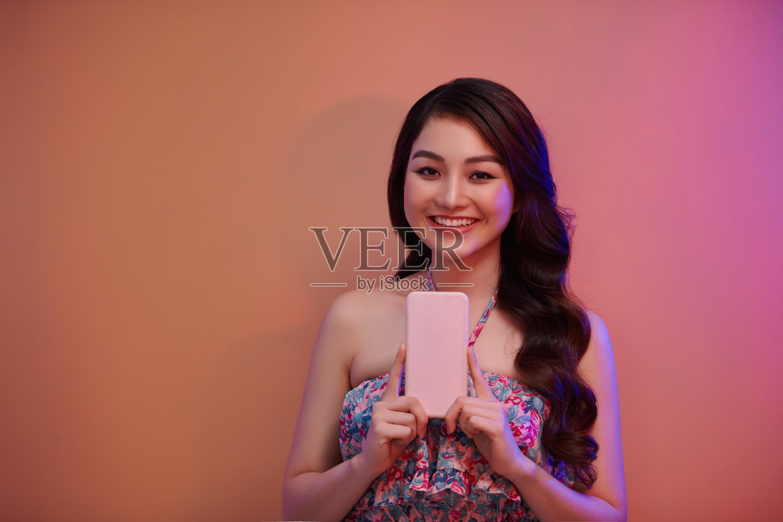 微笑的年轻女子女孩摆姿势孤立在霓虹灯工作室肖像照片摄影图片