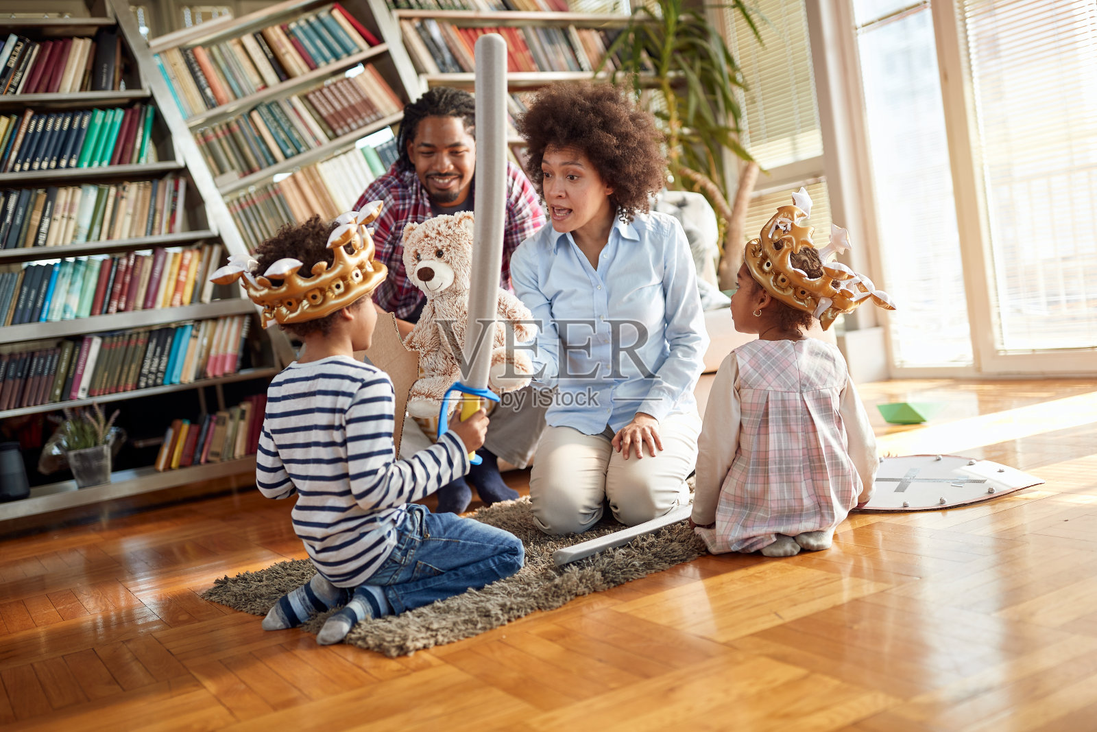 年轻的父母在家里和孩子一起玩的时候和他们说话。家人，在一起，爱，玩耍的时间照片摄影图片