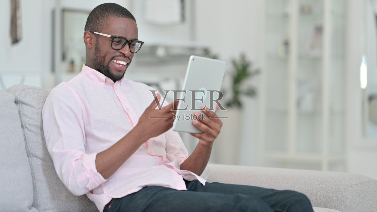 非洲年轻人在家用平板电脑进行视频通话照片摄影图片