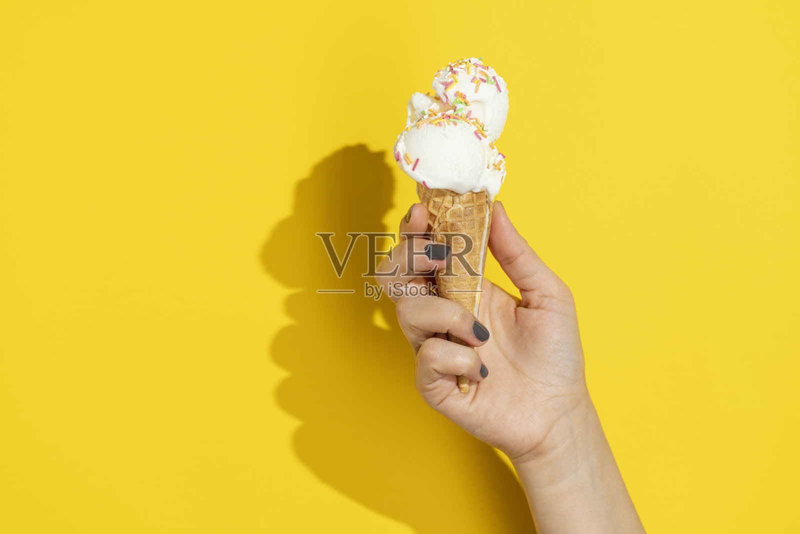 手拿香草冰淇淋蛋筒照片摄影图片