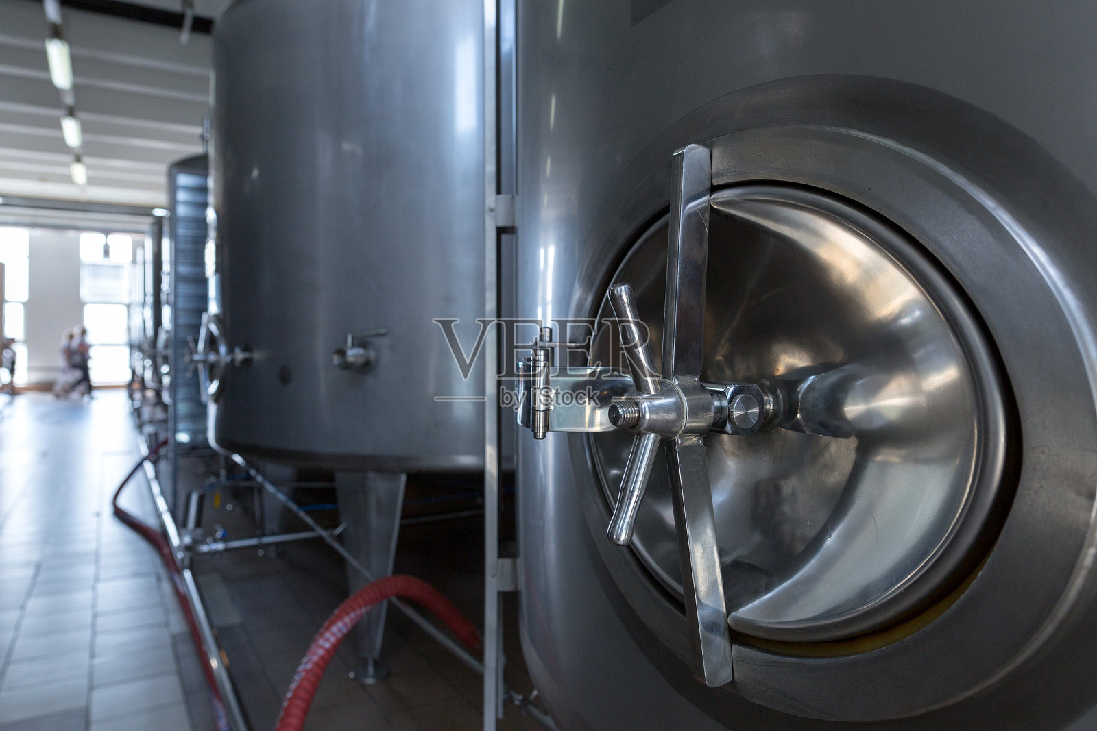 食品工业中用于液体的不锈钢桶、罐和其他容器。酒精或软饮料的工业生产照片摄影图片