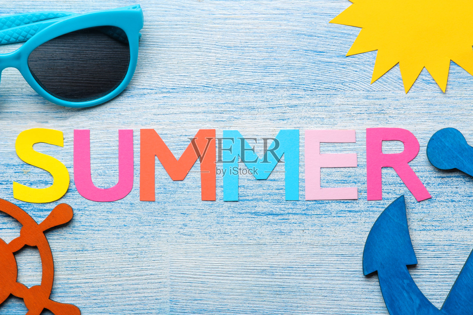 题字从纸上取下五彩缤纷的字母和贝壳以及夏天和海的配件放在一张蓝色的木桌上。夏天。放松。假期。俯视图照片摄影图片