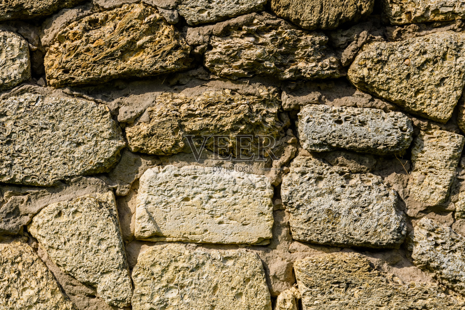 贝壳岩石的纹理为背景石灰石砖。自然模式照片摄影图片