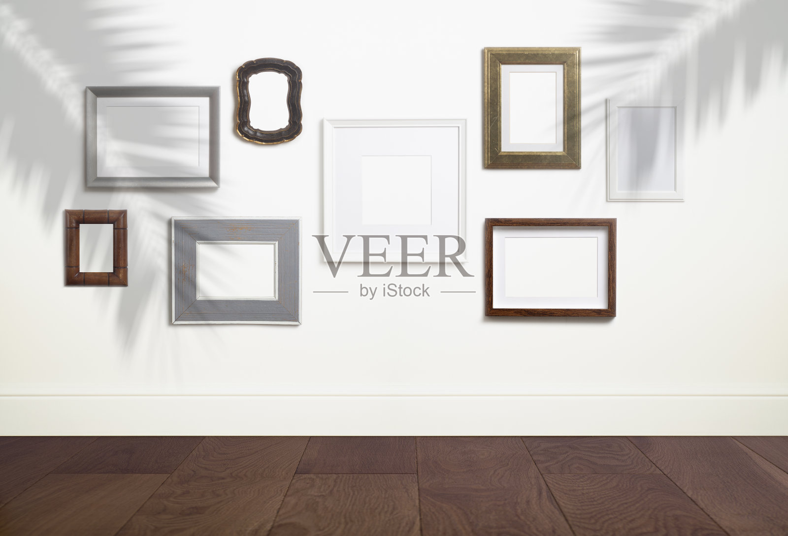 模拟空白的白色框架背景。不同的装饰空框架的照片或绘画在浅色斯堪的纳维亚极简主义室内在白色干净的墙壁。照片摄影图片