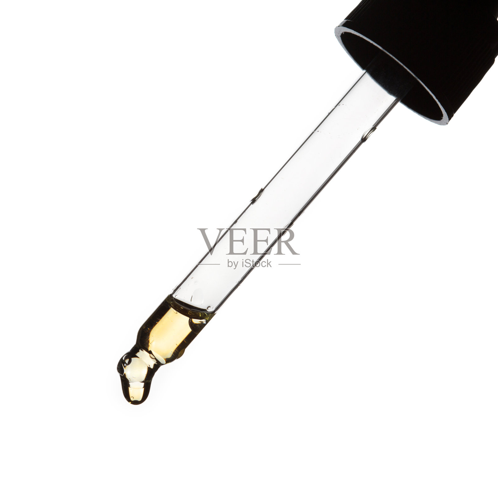 一滴精油滴从移液管特写在白色背景照片摄影图片