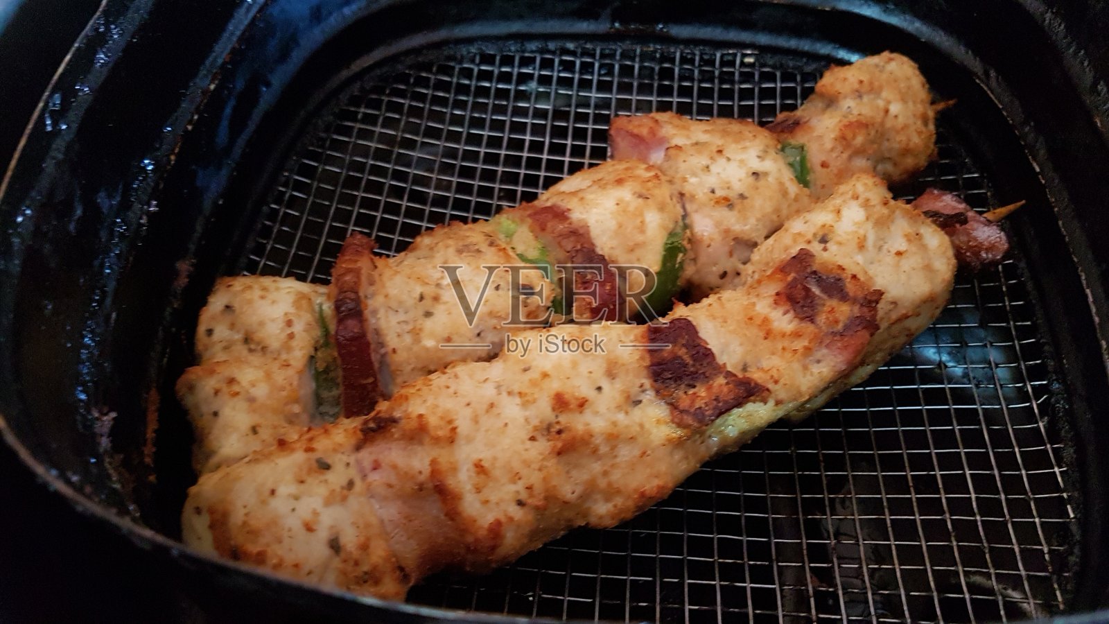 鸡，辣椒和培根串在空气炸锅/空气炸锅/油锅里照片摄影图片