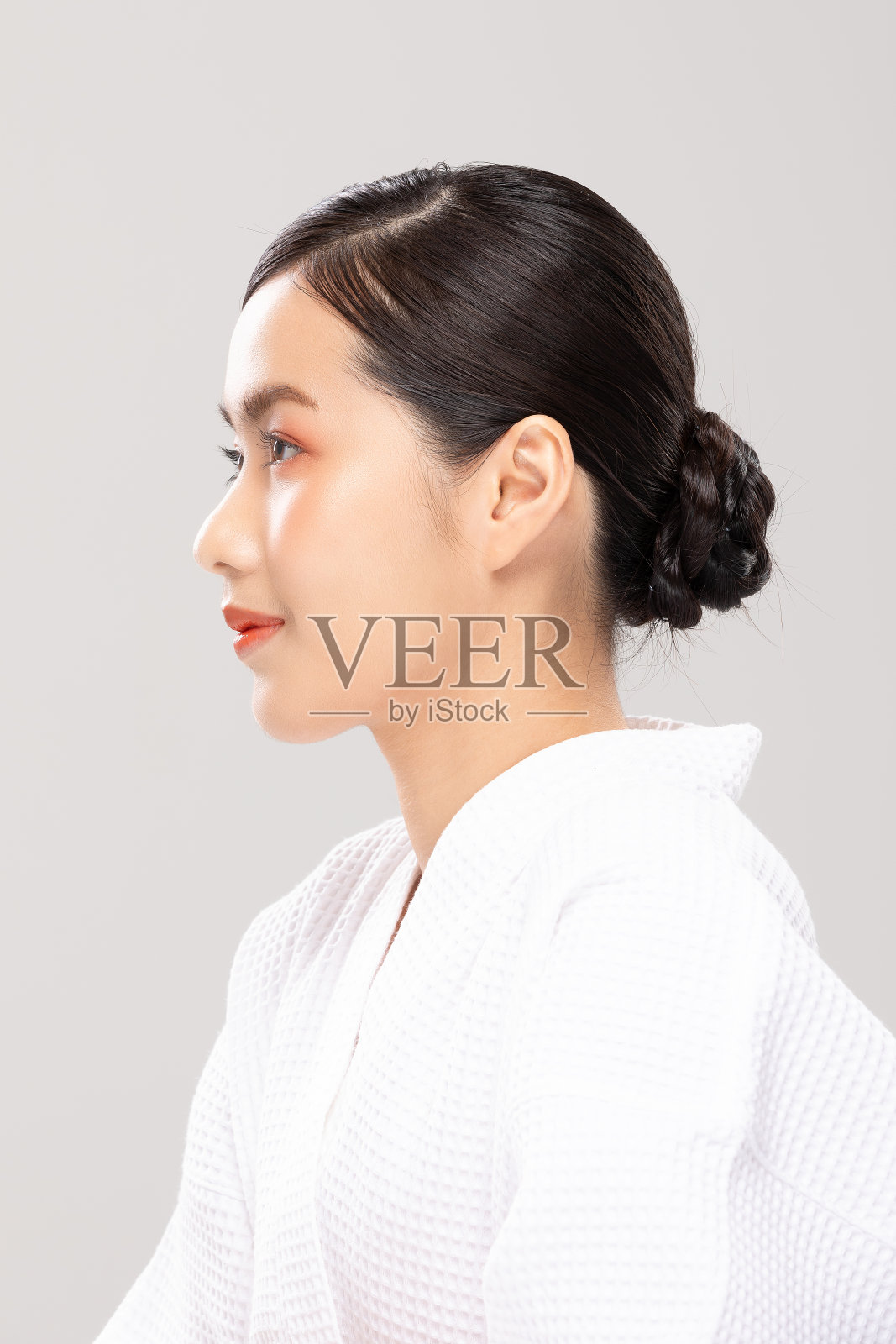 健康亚洲年轻女子微笑美丽的鼻子在完美的面部，健康女孩穿着浴袍与清洁和新鲜的皮肤隔离在灰色背景，美丽清晰的皮肤概念照片摄影图片