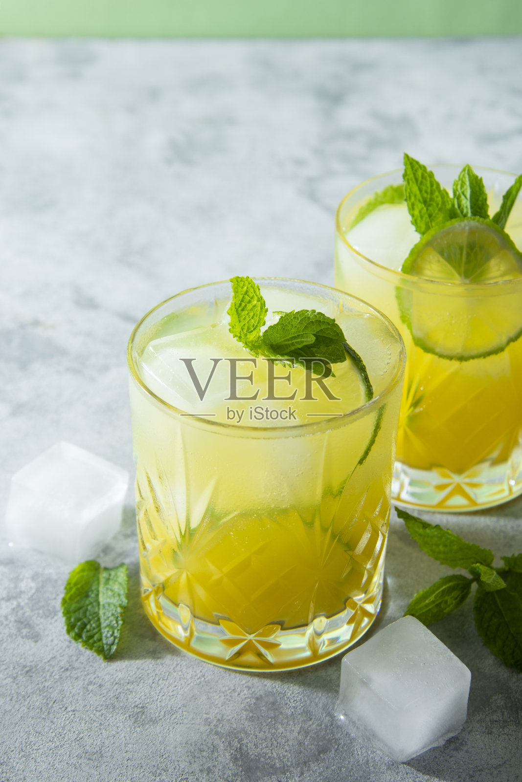 两杯清凉的冰饮料，果汁和酸橙水果，派对鸡尾酒照片摄影图片