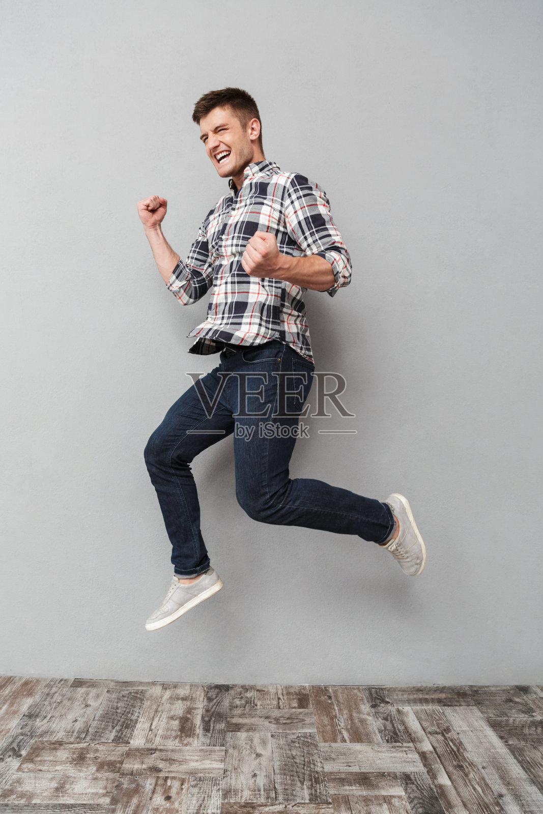 一个快乐的年轻人正在跳跃的全身像照片摄影图片