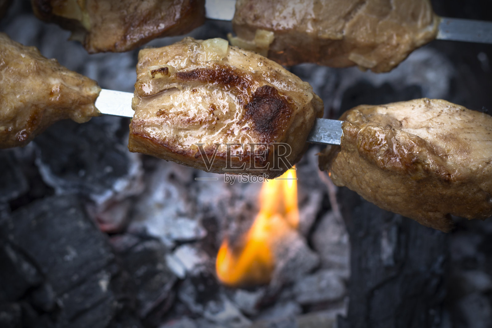 烧烤着火了。用烤肉串烤。照片摄影图片