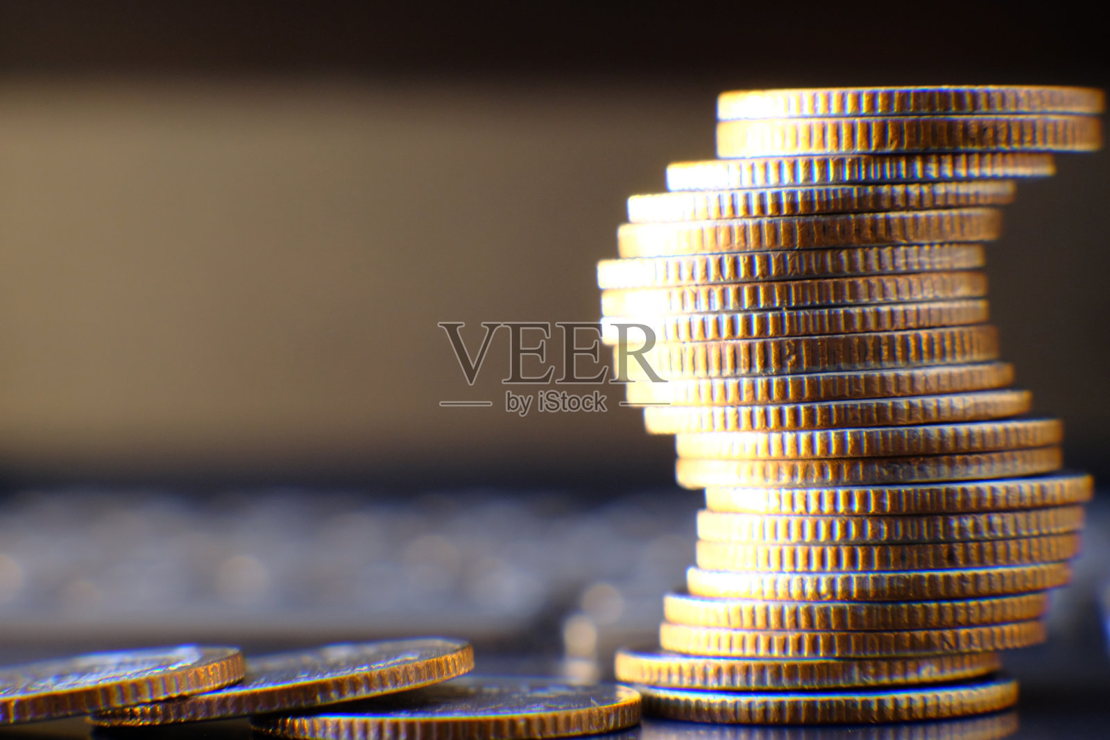 在笔记本电脑上堆叠硬币和图形背景和储蓄和业务增长的概念，金融和投资的概念照片摄影图片