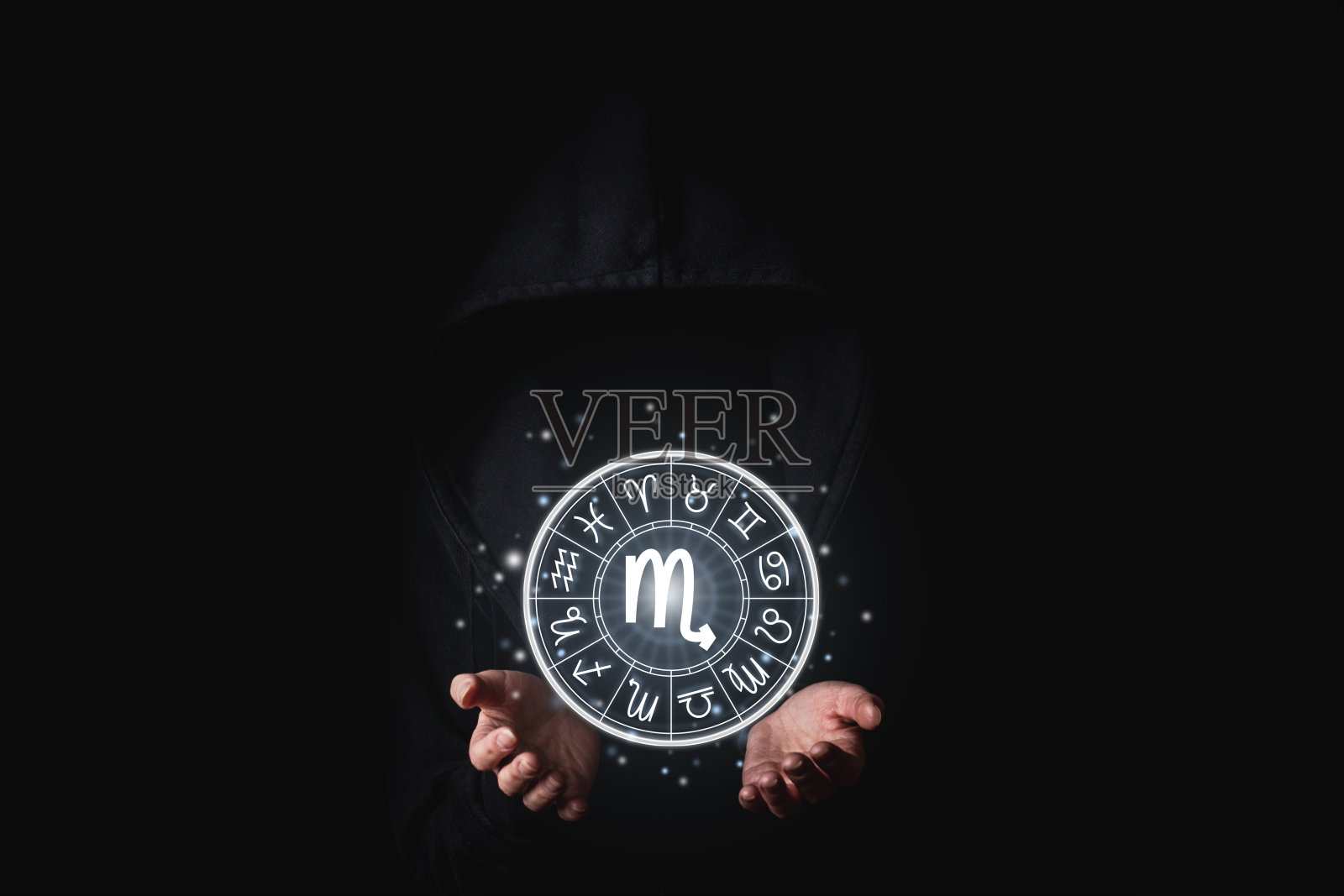 在黑色背景上，女性手握黄道十二宫的星象照片摄影图片