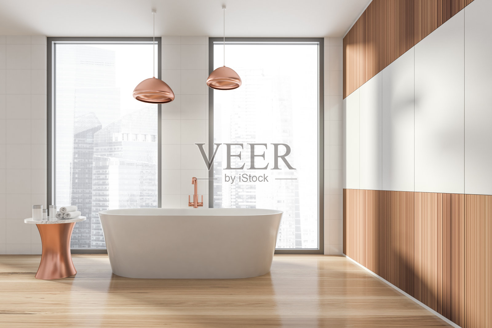 现代设计的浴室内部，白色椭圆形浴缸，青铜水龙头，灯。有毛巾和化妆品的小桌子。全景窗口与摩天大楼城市景观。木材料。照片摄影图片