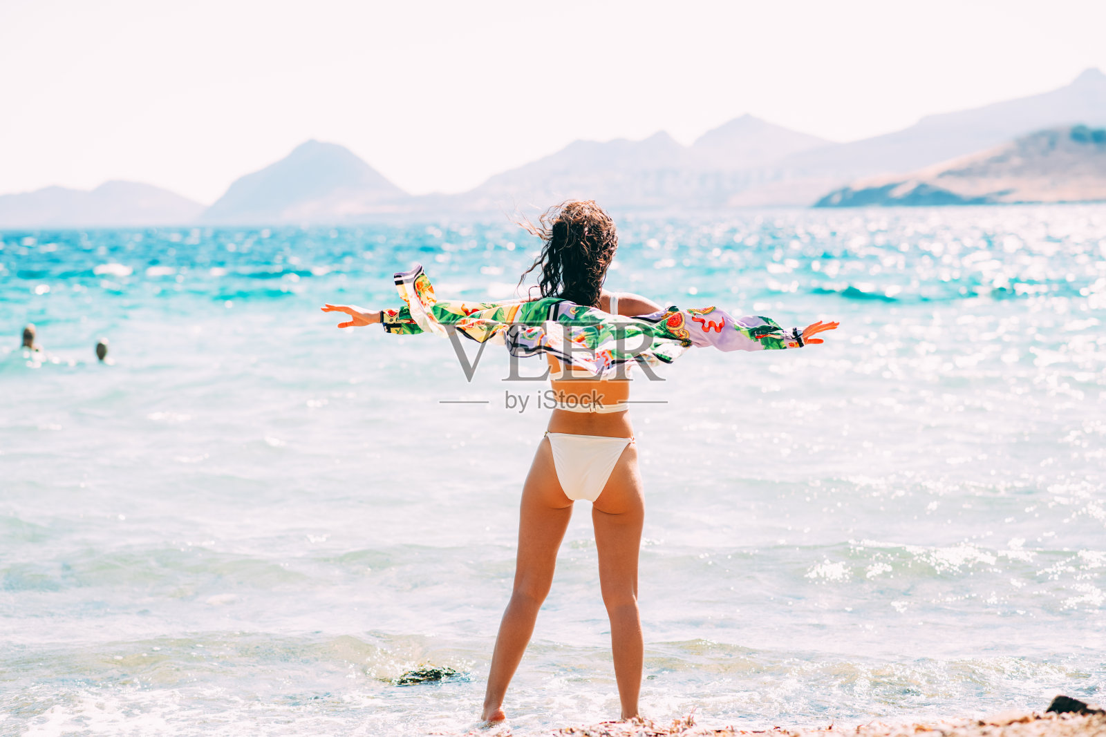 快乐的女人在沙滩上摆比基尼姿势照片摄影图片