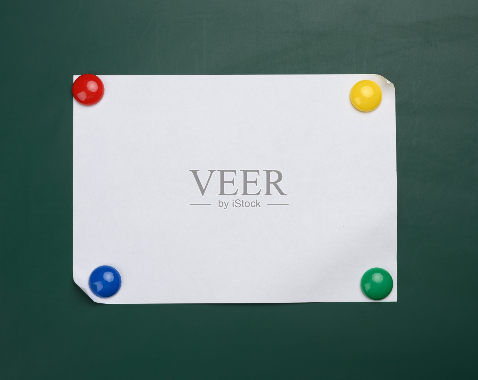 一张白纸a4纸挂在一块绿色的磁性板上。照片摄影图片