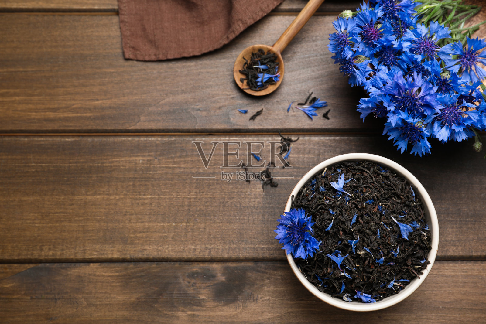 构图用干茶叶和矢车菊放在木桌上，平铺。空间的文本照片摄影图片