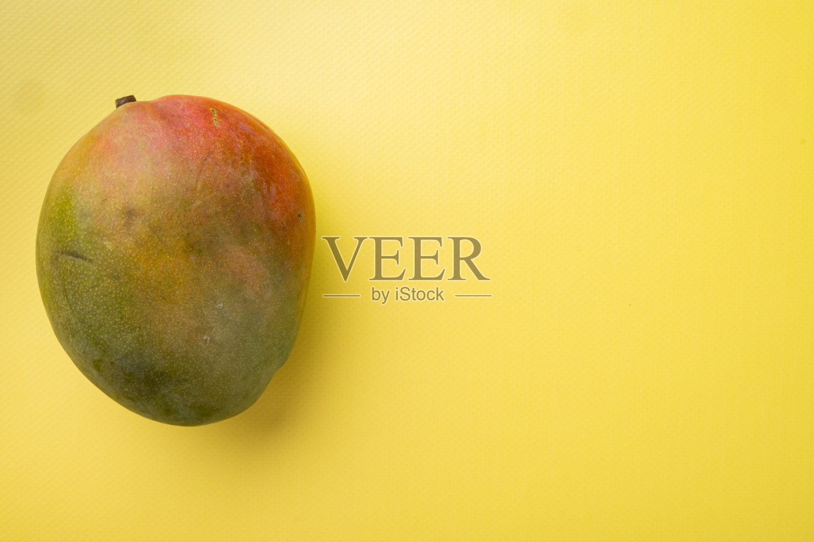 芒果整个水果，在黄色纹理的夏季背景，俯视图平铺，与文本复制空间照片摄影图片