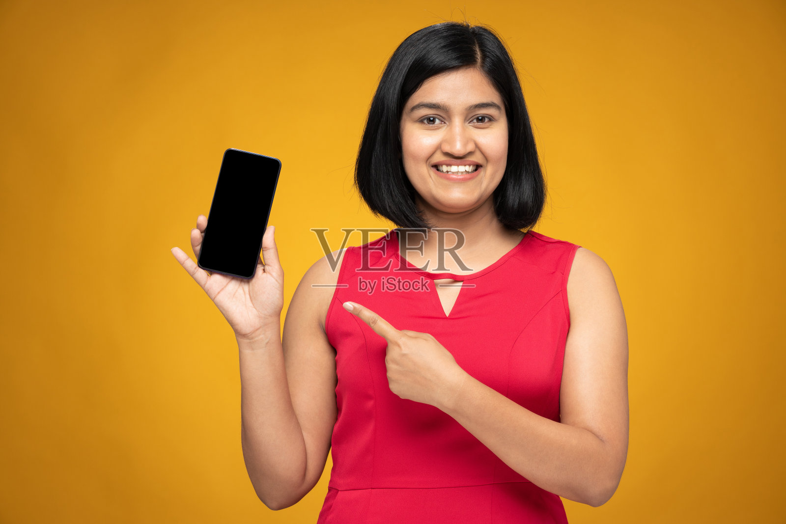 年轻妇女的肖像在短头发站孤立的黄色背景:股票照片照片摄影图片