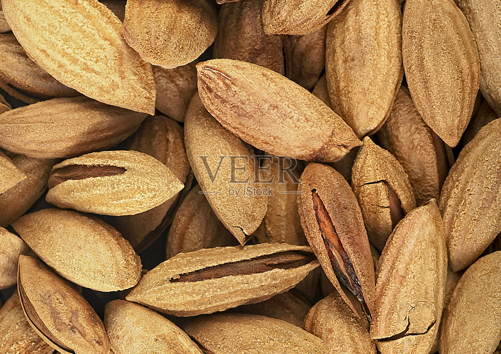 以未去皮的杏仁为背景。以自然为背景的健康饮食理念。照片摄影图片