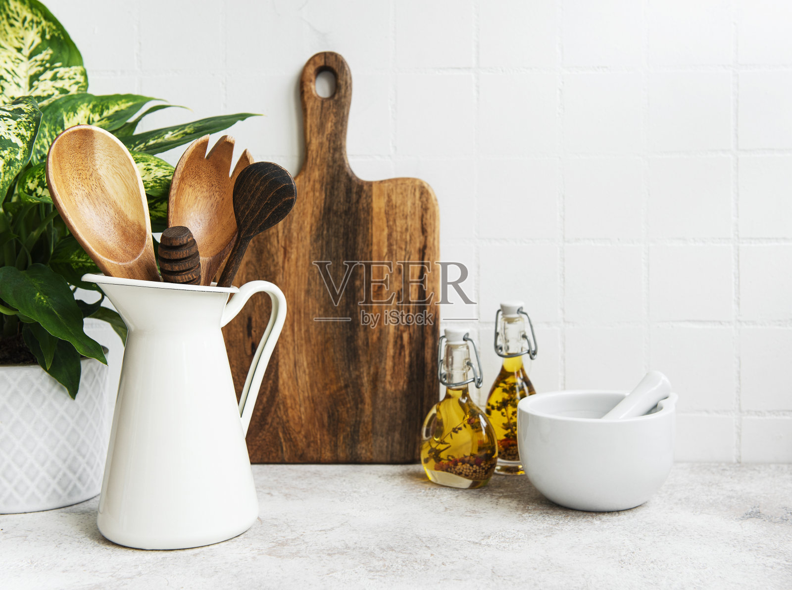 厨房用具、工具和餐具放在背景白瓷砖墙上。照片摄影图片